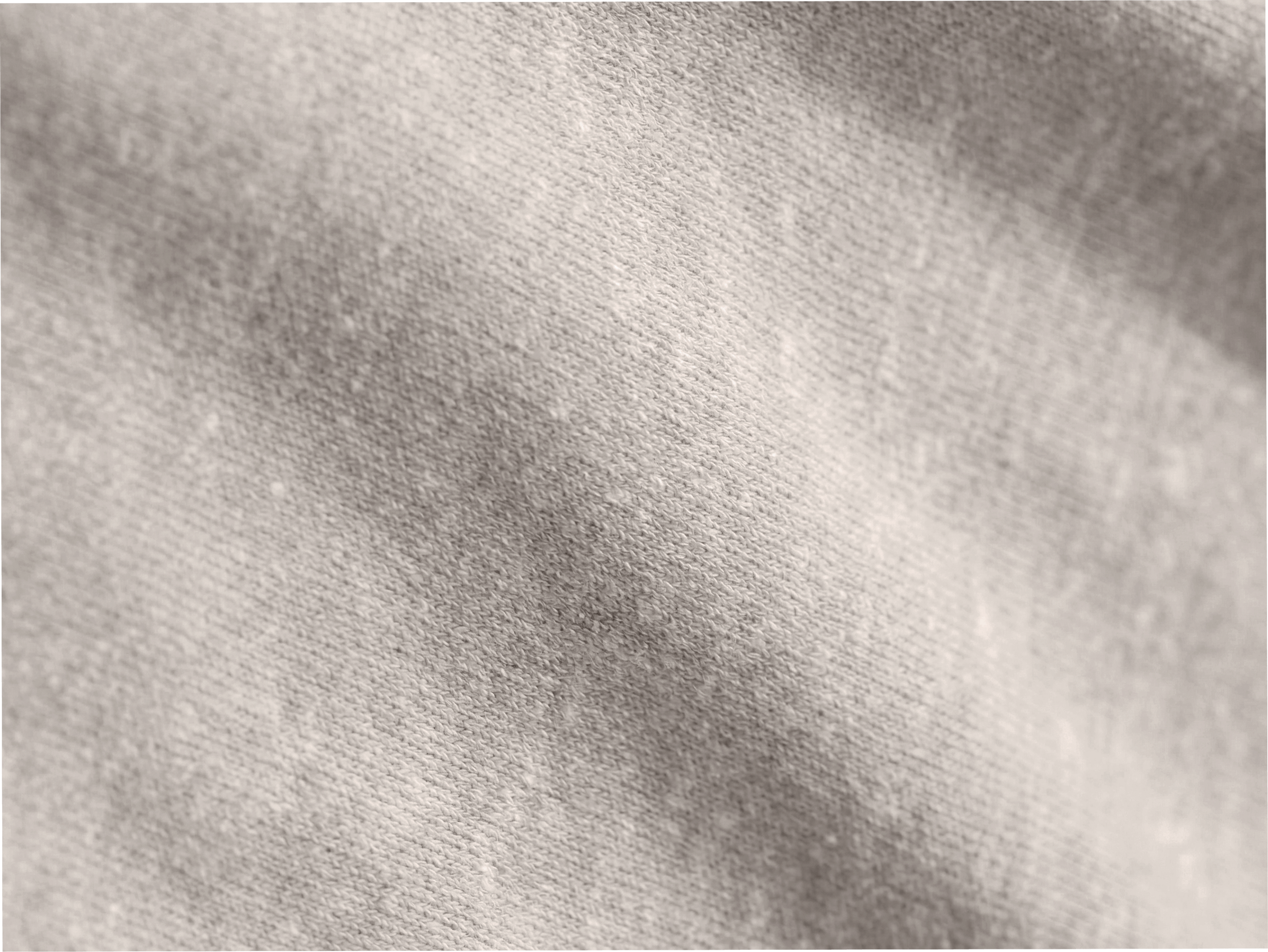 Détail rapproché d’une maille fine beige révélant le grain du tissu.